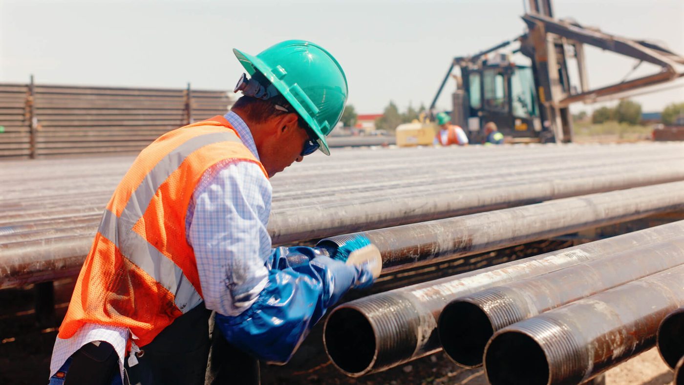 AC Pipe crew inspecting oilfield pipe